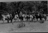 J. M. Hutchings and party in front of Yosemite Chapel at its original location near 4 mile trail. Andy Van Rapper, guide, at extreme right.