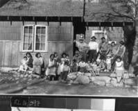 Group of Native Americans in Indian Village at H. Johnson's house. This is taken at same time as RL-02,098. Front Row L-4: 1) Jackie Oliver 2) Hazel Oliver 3) Amy Hilliard 4) Agnes Castro 5) Hazel Warren 6) Unknown 7) Fred Beale 8) Unknown 9) Joe Rhoan [?] 10) Stanley Castro 11) Harold Rhoan 12) Peggy Beale (?) 13) Pat Castro (Brochini) 14) Amy Rhoan 15) Joe Rhoan [?] 16) Peggy Beale (?) 17) Velda Johnson (Leemaster); Back Row: 18) Al Rhoan 19) Pete Hilliard 20) George Warren 21) Nelson Oliver 22) Irene Beale, wife of Lawrence Beal