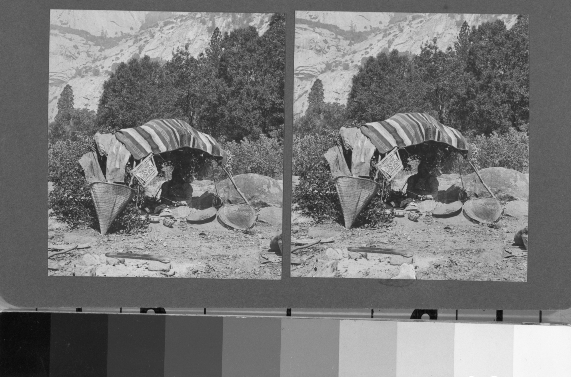 Copy Neg: 11/85 by M. Dixon. Stereo from L. Smaus collection. Sepia-toned prints on grey card. Woman making basket under make-shift shade. See also: RL-17,279 (5 x 7 neg)