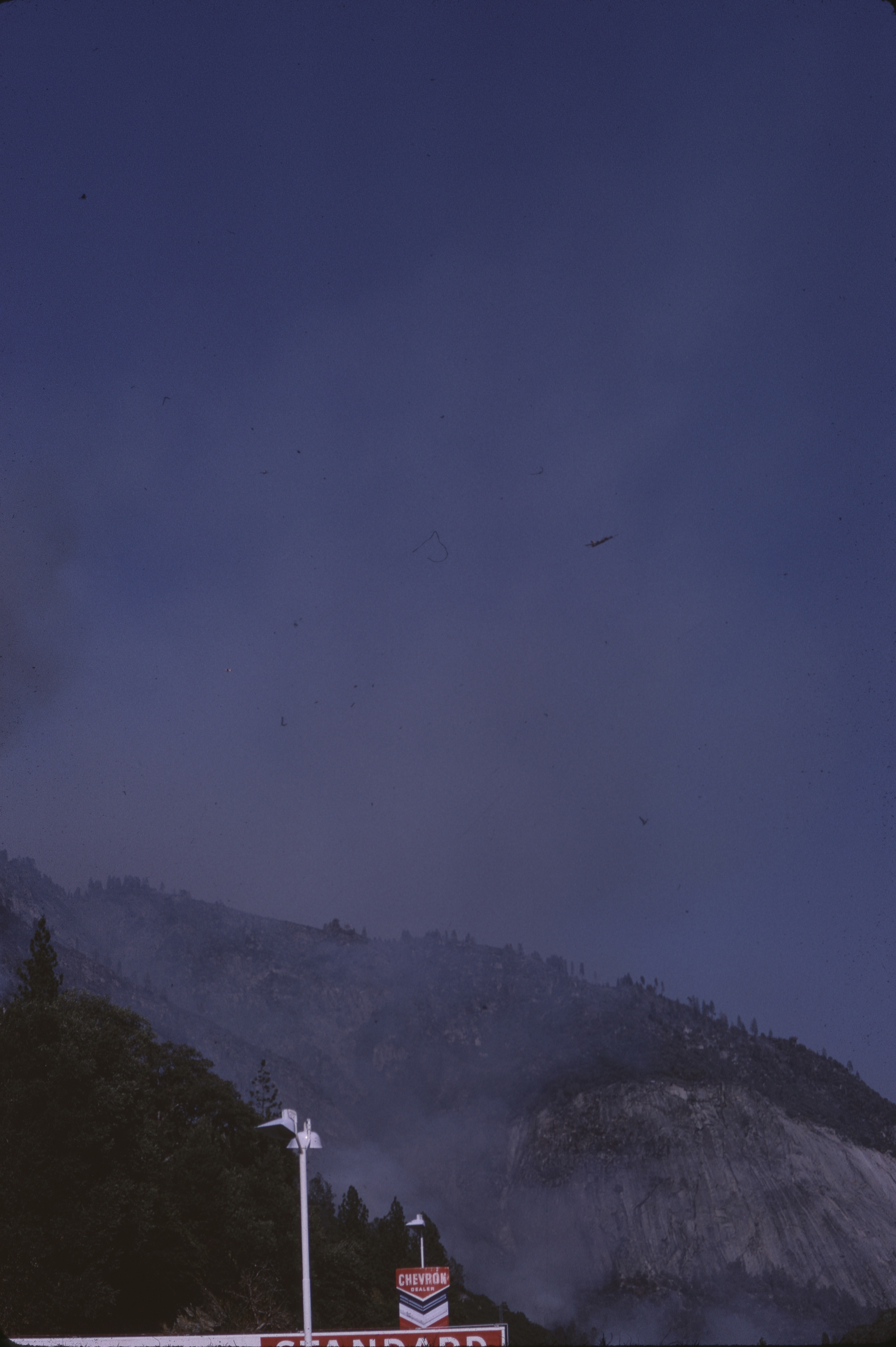 View of canyon fire and smoke with Chevron gasoline station in foreground
