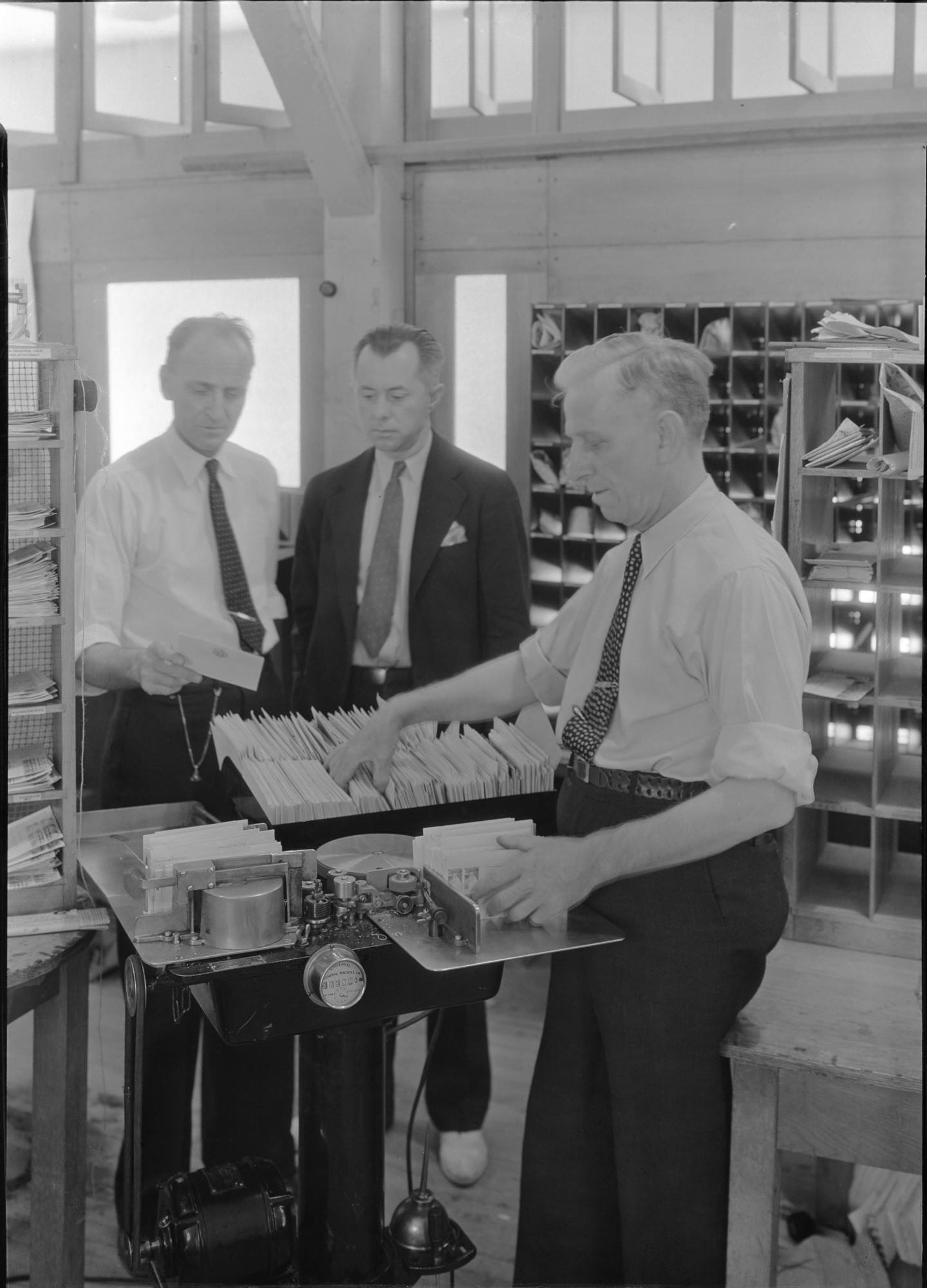 Fred Alexander, Postmaster, Robert Fellers, Supt. Division of Stamps, and Charles F. Anderson-postal advisor.