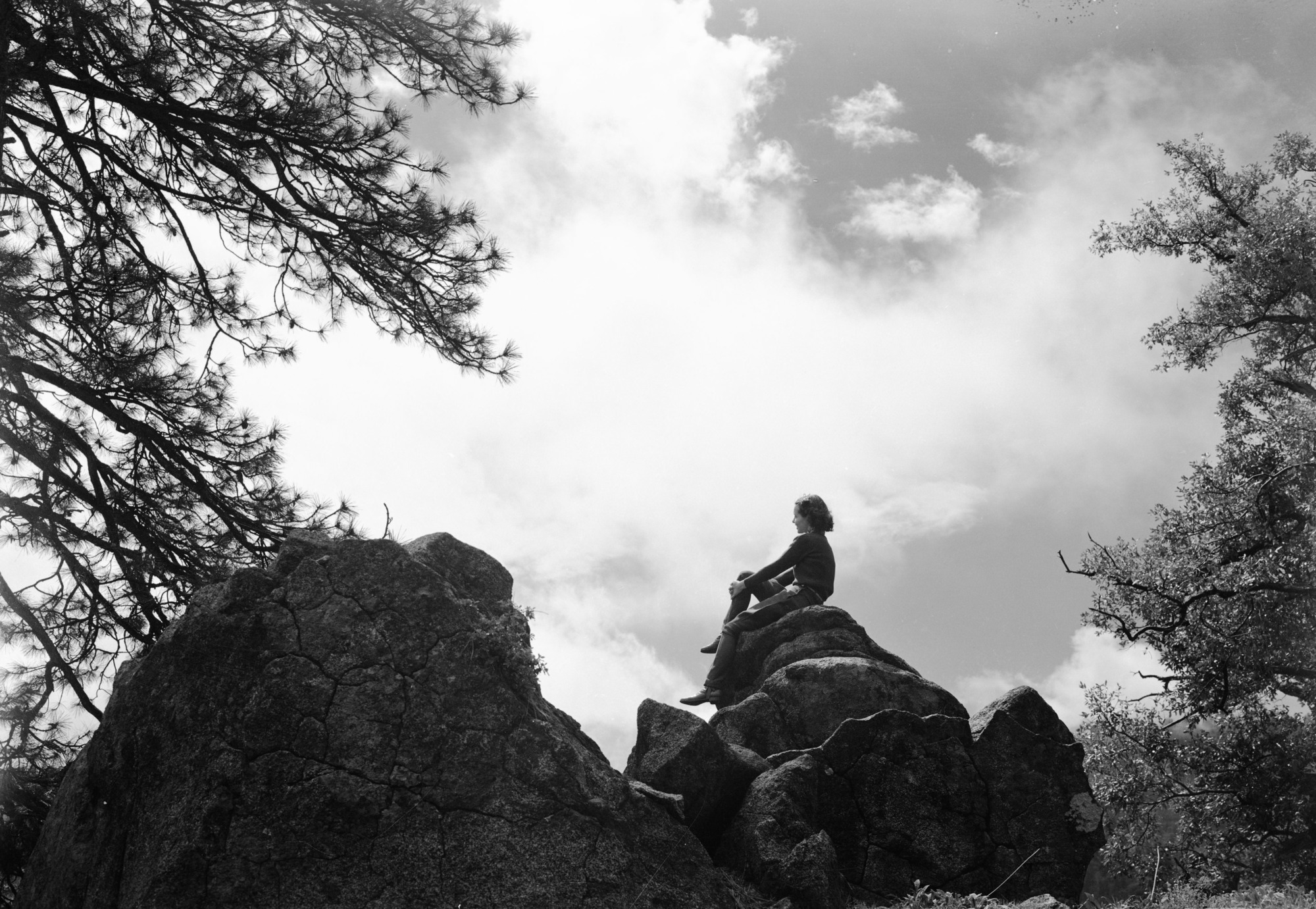 Girl on cloudy skyline