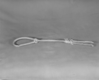 Private Collection. Object: Miwok looped stirring stick. Dimensions: 19 1/4" long. Materials: Oak and cotton string. Collection History: Purchased from Mrs. Mary Longfellow Poncho (Maggie Longfellow Antoninni's mother). Photographed by Michael Dixon. Catalogued by Craig Bates and Barbara Beroza. Yosemite Collections, National Park Service.