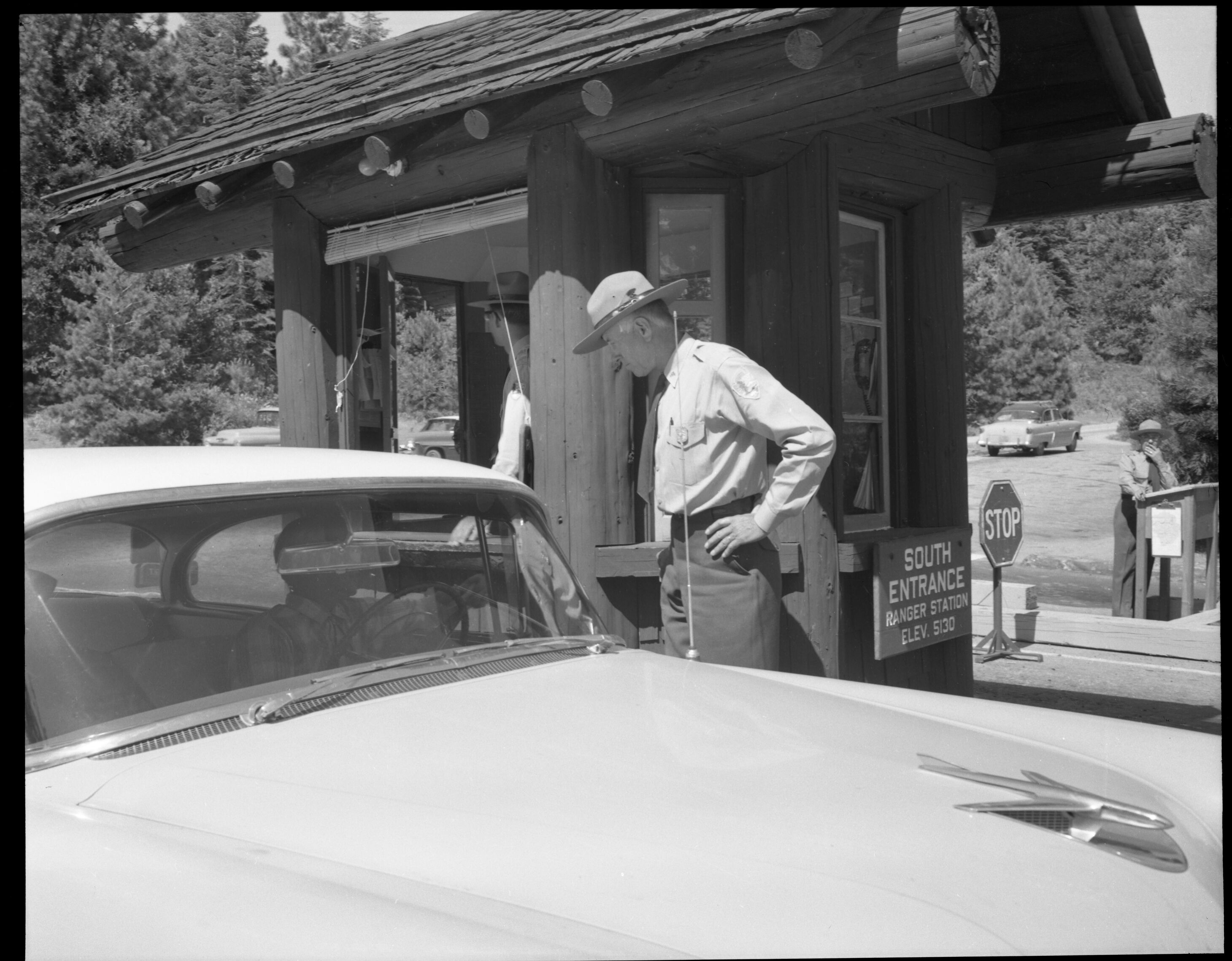 Supervisory Park Ranger Sam Clark giving information to departing visitor at South Entrance Station.