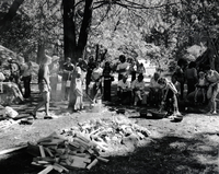 Cooking acorn mush at the Roundhouse Dedication, Yosemite Valley. Julia Parker, standing with basket in hand. Felicia Espina, (left) and Kim Hamilton (right) cooking in basket.