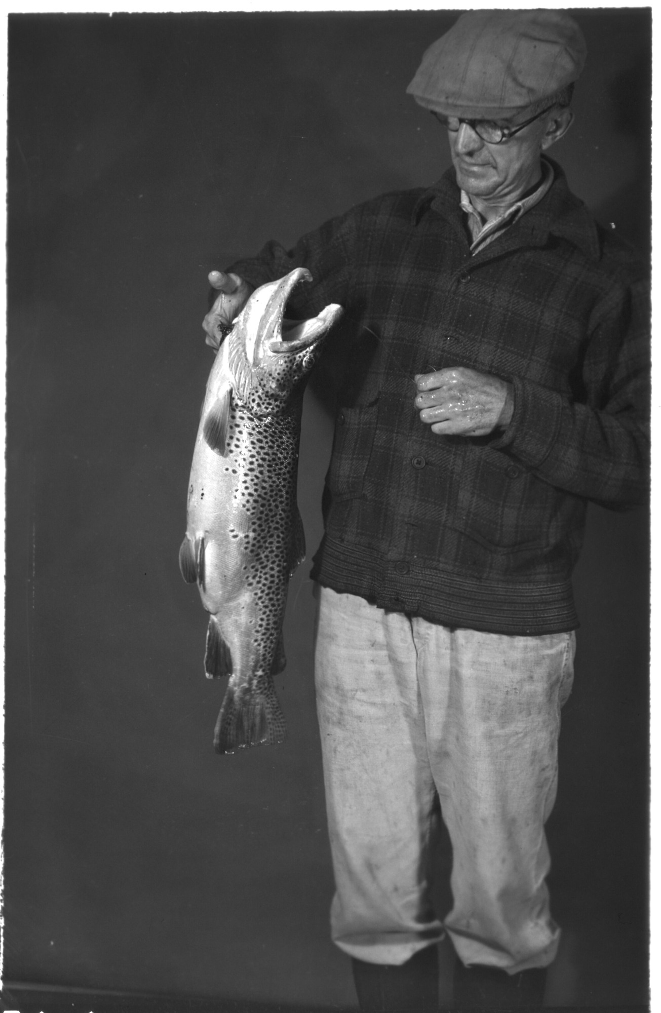 I.I. Gilbo , fisherman with catch. Remarks: Taken on the First day of season. Flashlight photo.