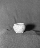 Marie Rozier Collection, Catalog No. 25. Object: Chinese basket. Dimensions: 3 1/2 x 4 1/2". Materials: Split rattan, reed. Technology: Single rod, interlocking stitch. Collection History: Type commonly exported from China in early 20th Century. Gift of G. DuGay. Photographed by Michael Dixon in December 1982. Catalogued by Craig Bates and Barbara Beroza. Yosemite Collections, National Park Service.