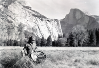 Maggie Howard beating grass seeds into burden basket. Probably taken during filming of movie "Yosemite Native Americans". Baskets were in Yosemite Collections (@ that time): seed beater - Miwok; burden basket-Wintu or Atsugewi - scene not accurate description of the activity.