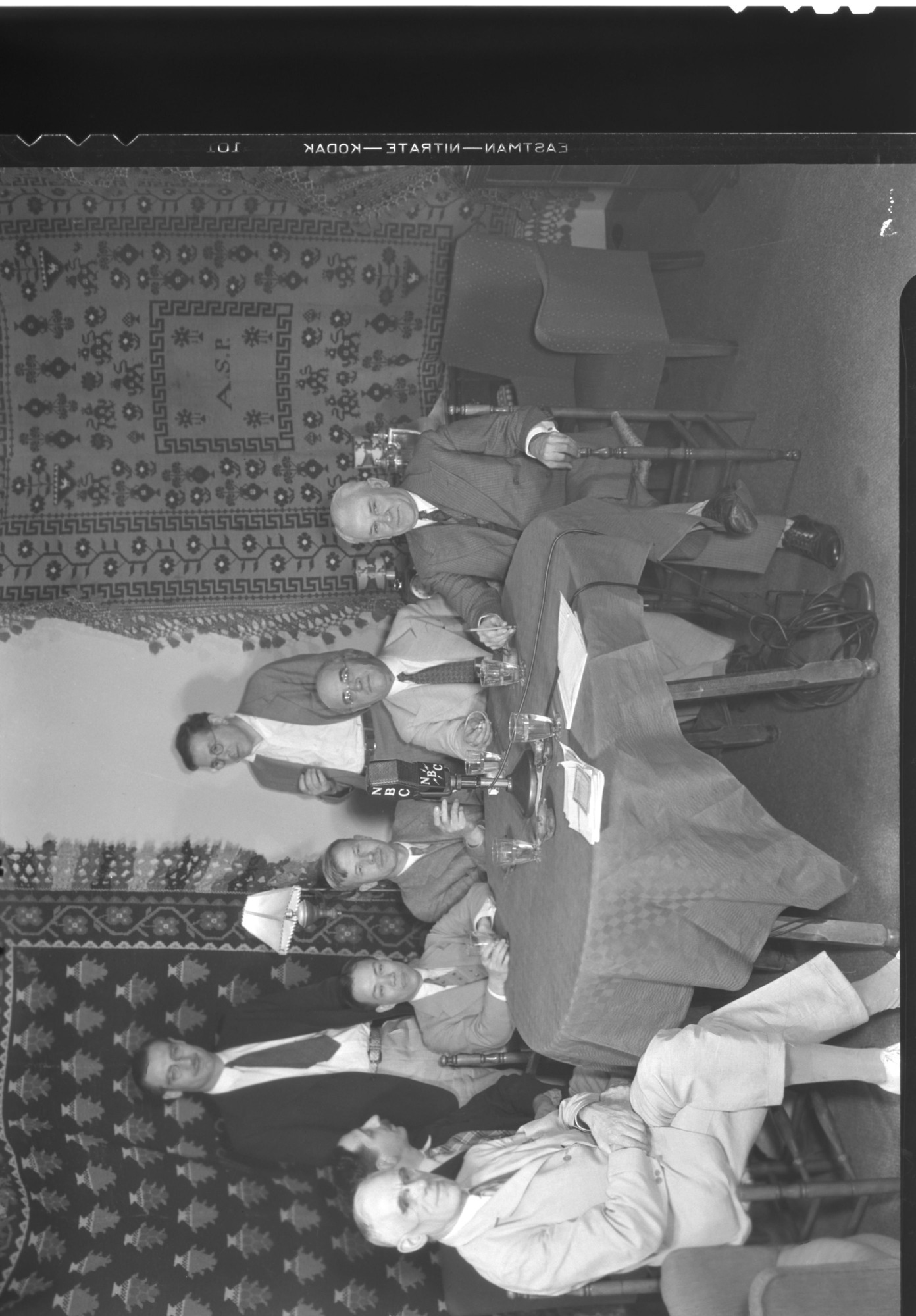 Institute of Pacific Relations. L-R: Lord Snell, British Parliament; Rogger Levy, Sec. Committee on Pacific Problems, Paris; Dr. Leonard S.L. Hsu, Peiping; Dr. R.C. Wallace, Canada; Albert Sarraut, former Premier of France; Robert Andrews Millikan, physicist; Standing: Don Thompson, NBC; Bruno Lasker, broadcasting for IPR.