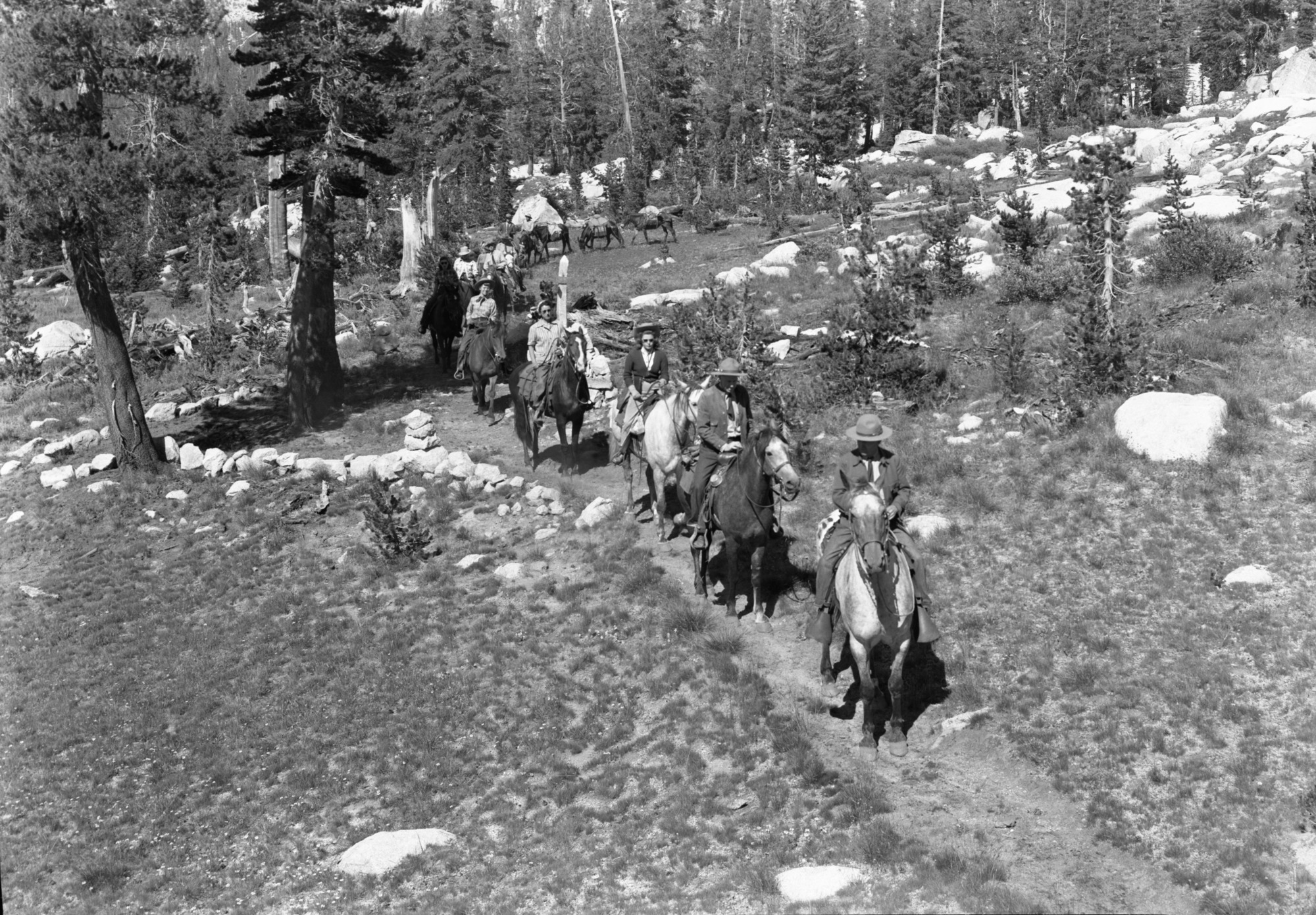 Supt.'s party at Triple Peak Fork trail turn-off from Isberg Pass Trail. Members of the party: Supt. Frank Kittredge, Mrs. Kittredge, Catherine Jane Kittredge, Majorie Williams, John Wegner, Chief Townsley, Harry During, Mary During, Louie Austin (packer), and Ralph H. Anderson (photographer).