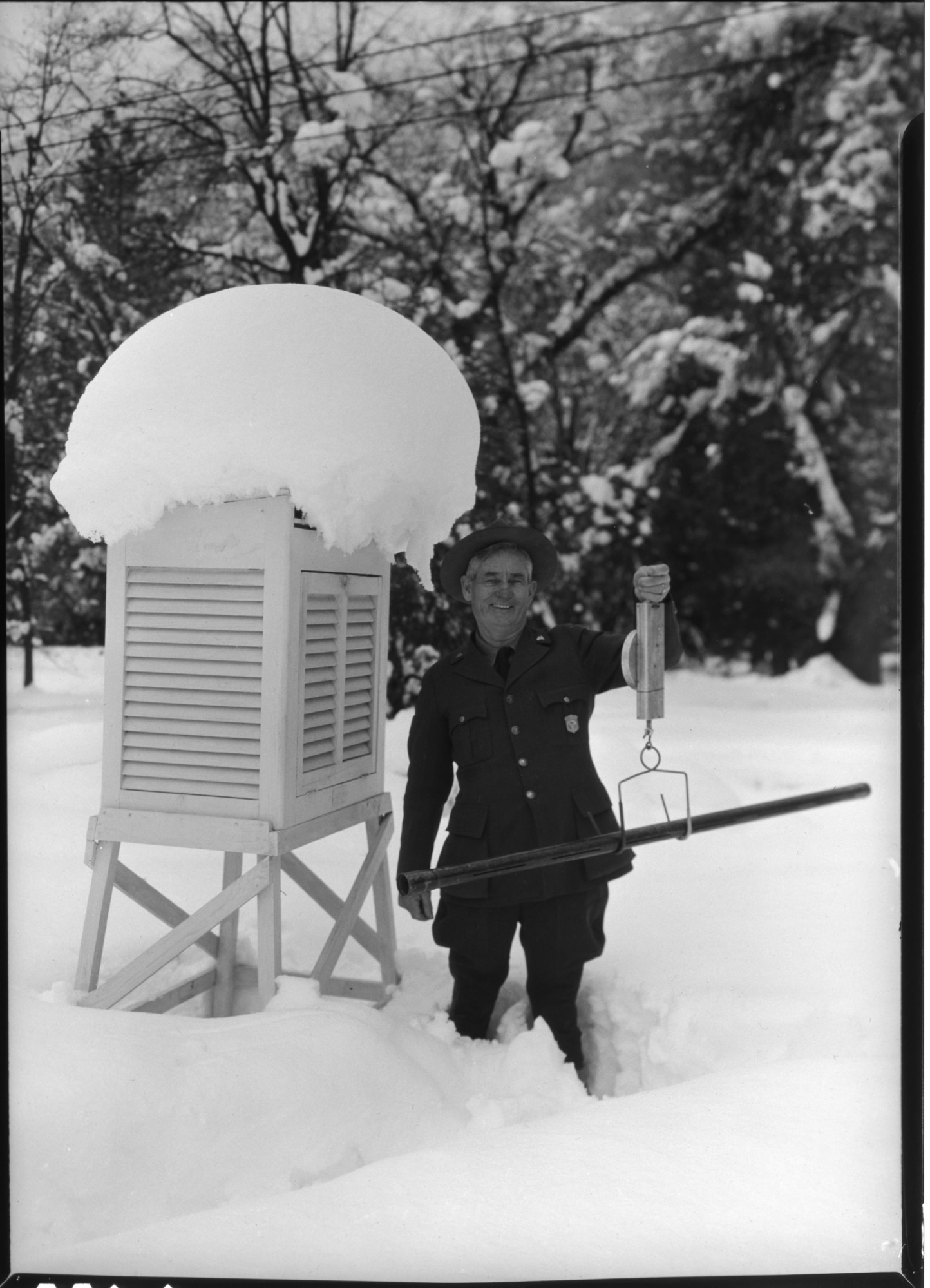 Charles Adair measuring snow.