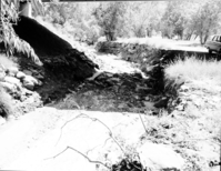 Flood damage - water removed several of the large boulders used as revetments under new Oak Creek bridge.
