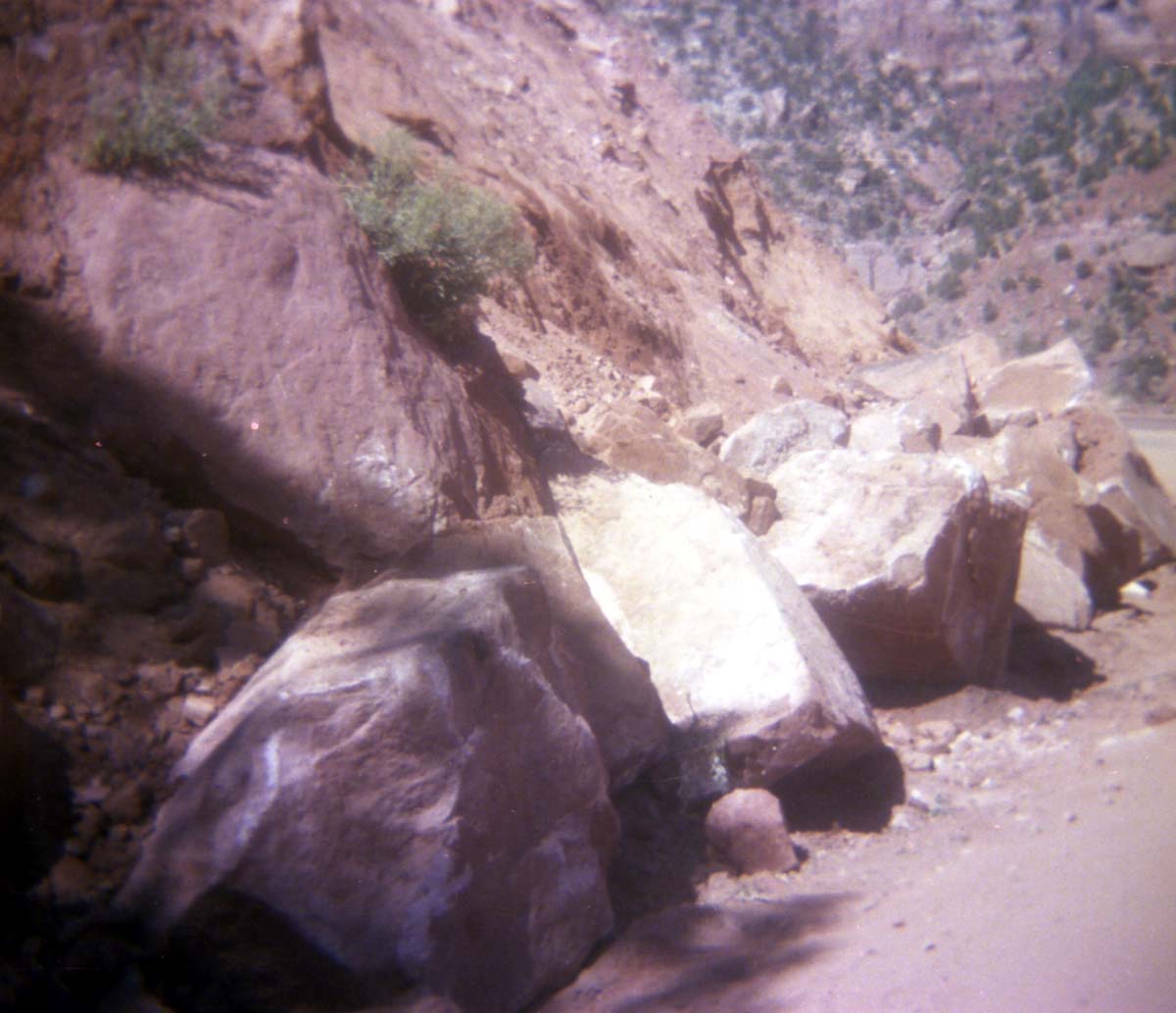 Color Photo of a rock slide along road.