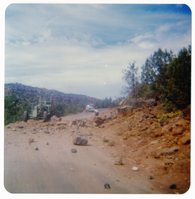 Rock pile across road with men working to clear it along the Kolob Terrace Road.