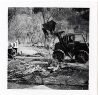 Construction vehicle cleaning and clearing in campground area.