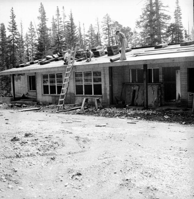 Men working on roof during construction of employee residential multiplex.