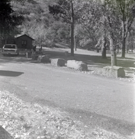 Road and car pulling into the parking area near the Grotto.