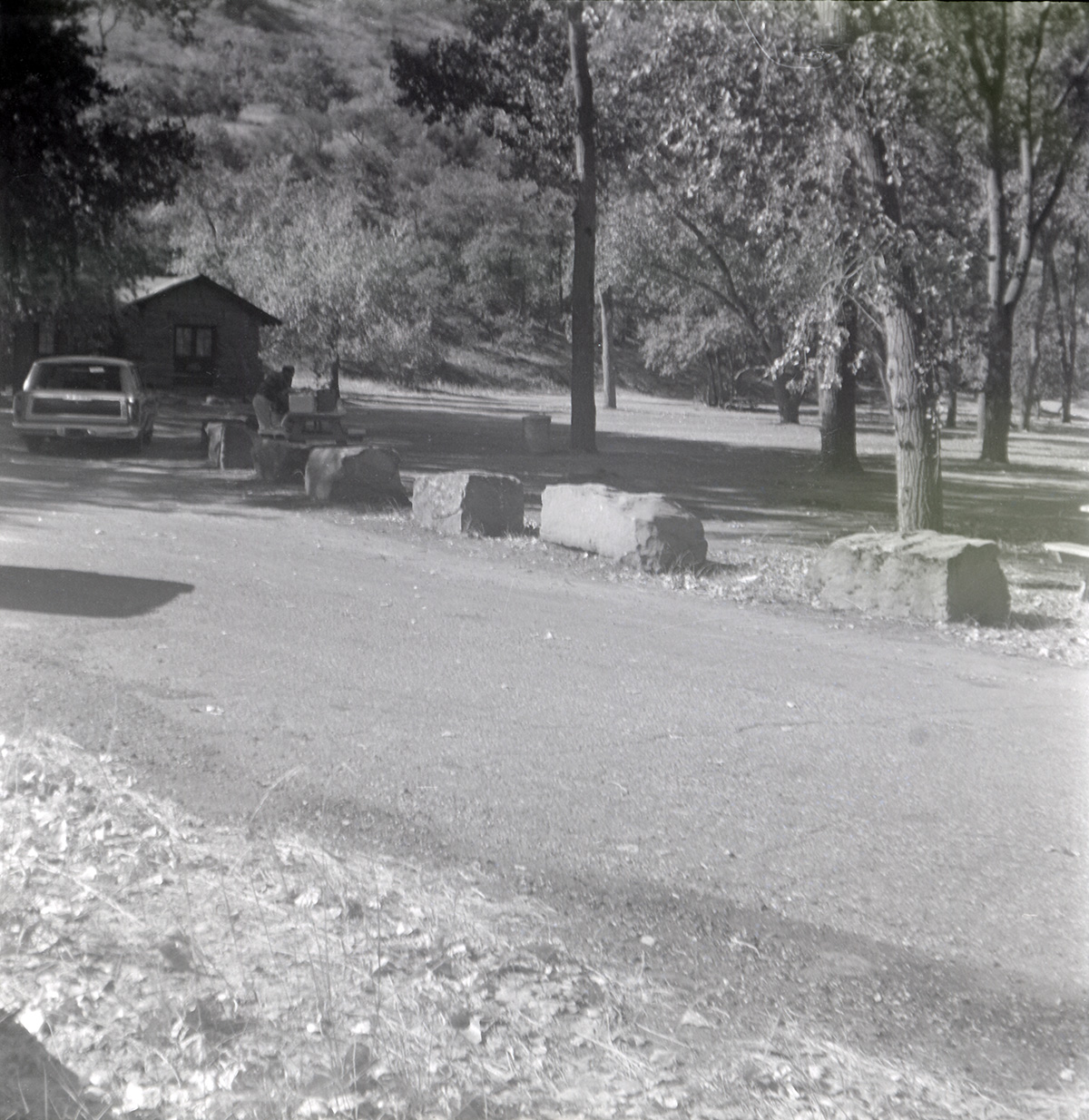 Road and car pulling into the parking area near the Grotto.
