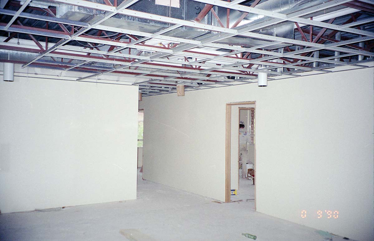 Park Headquarters Renovation: man painting in west corner hallway and offices, upper level.