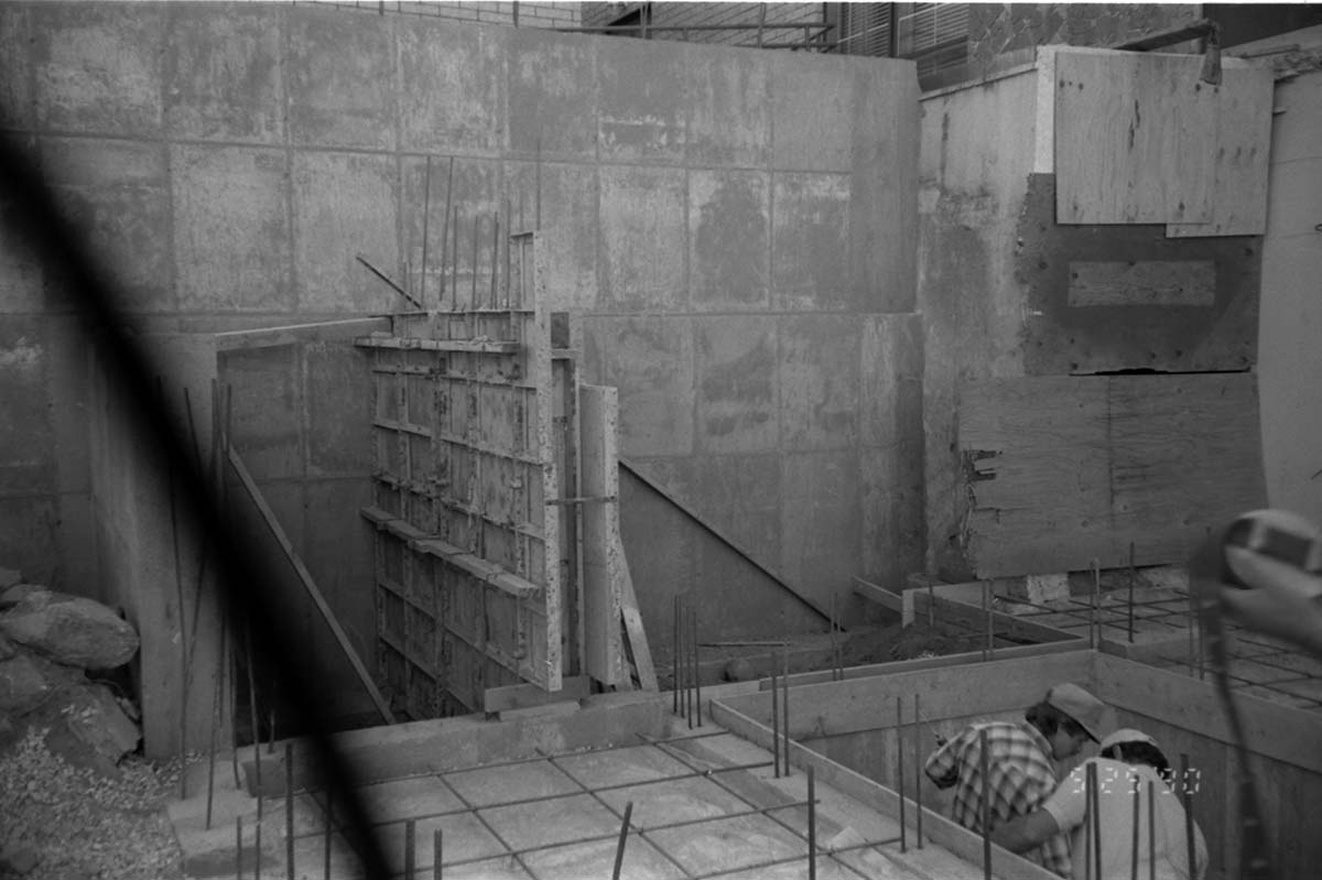 Workers performing construction duties during the construction of headquarters addition.