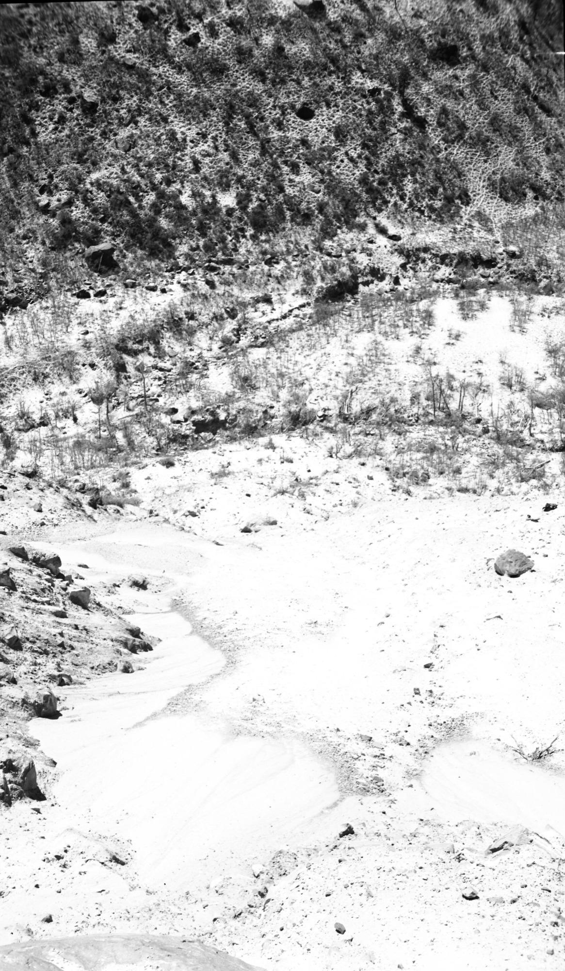 Rock slide damage repair work to park road in Zion Canyon. Removal of slide material and building of a rock retaining wall to protect roadway.