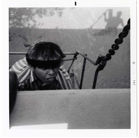 Navajo worker placing pipe on side of bridge during the Watchman housing utility project.