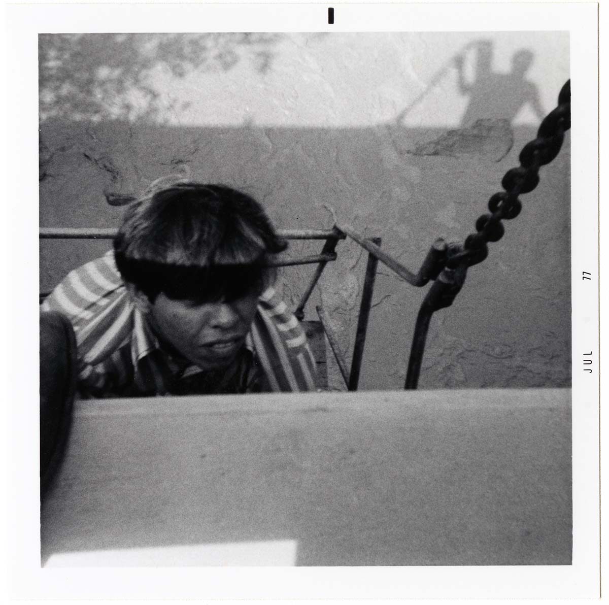 Navajo worker placing pipe on side of bridge during the Watchman housing utility project.