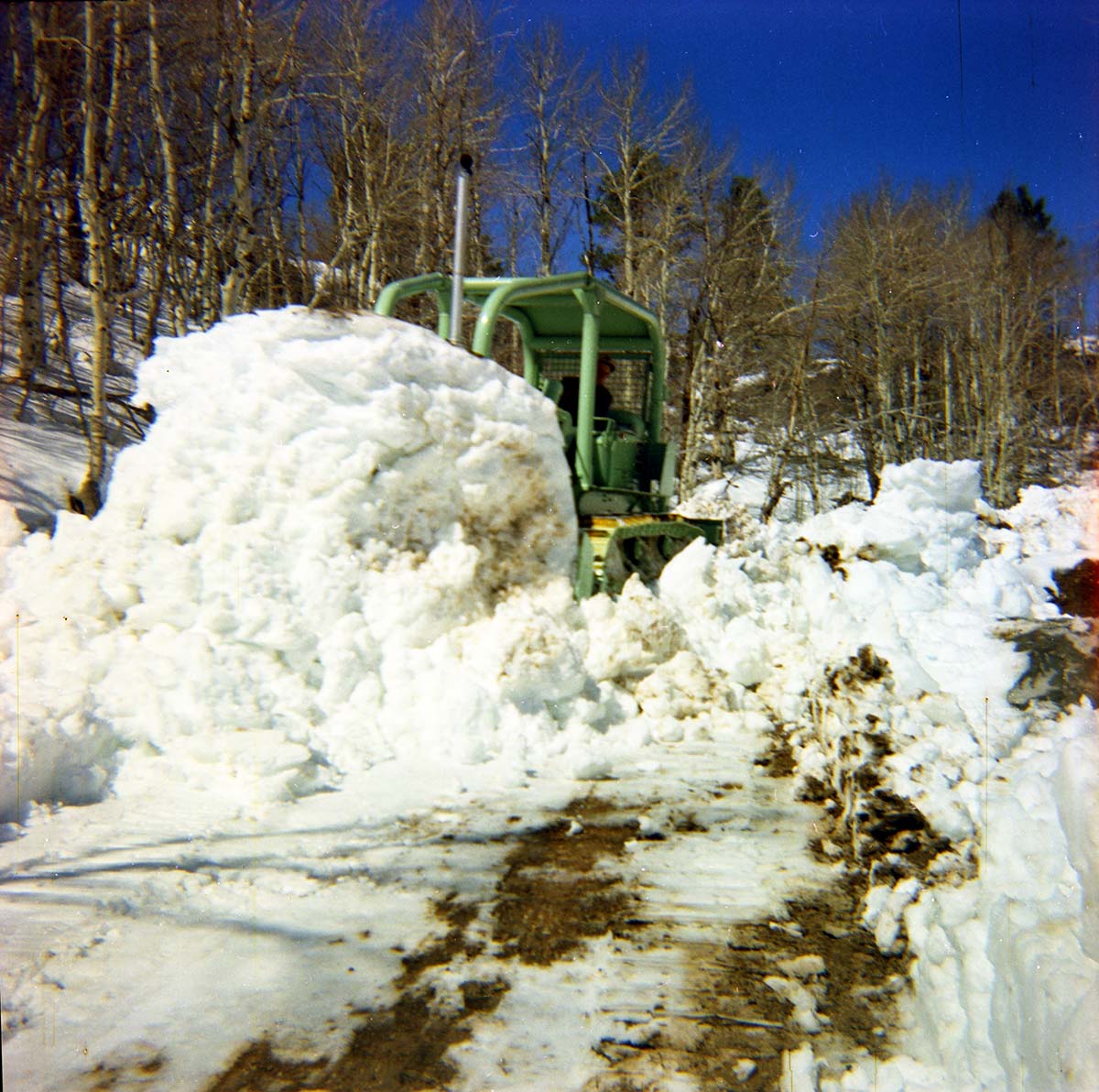 Color Photos of the parks snowplow/ tractor.