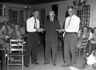 Superintendent Paul R. Franke presenting awards to Wilcox and Campbell at the ranger dormitory.