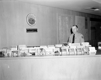New display area for Zion Natural History Association and other sales publications at Visitor Center information desk- Chief Naturalist Carl E. Jepson in photo.