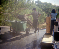 Workers standing by as the roofing cart is filled with roofing materials during the headquarters/visitor center roofing project.