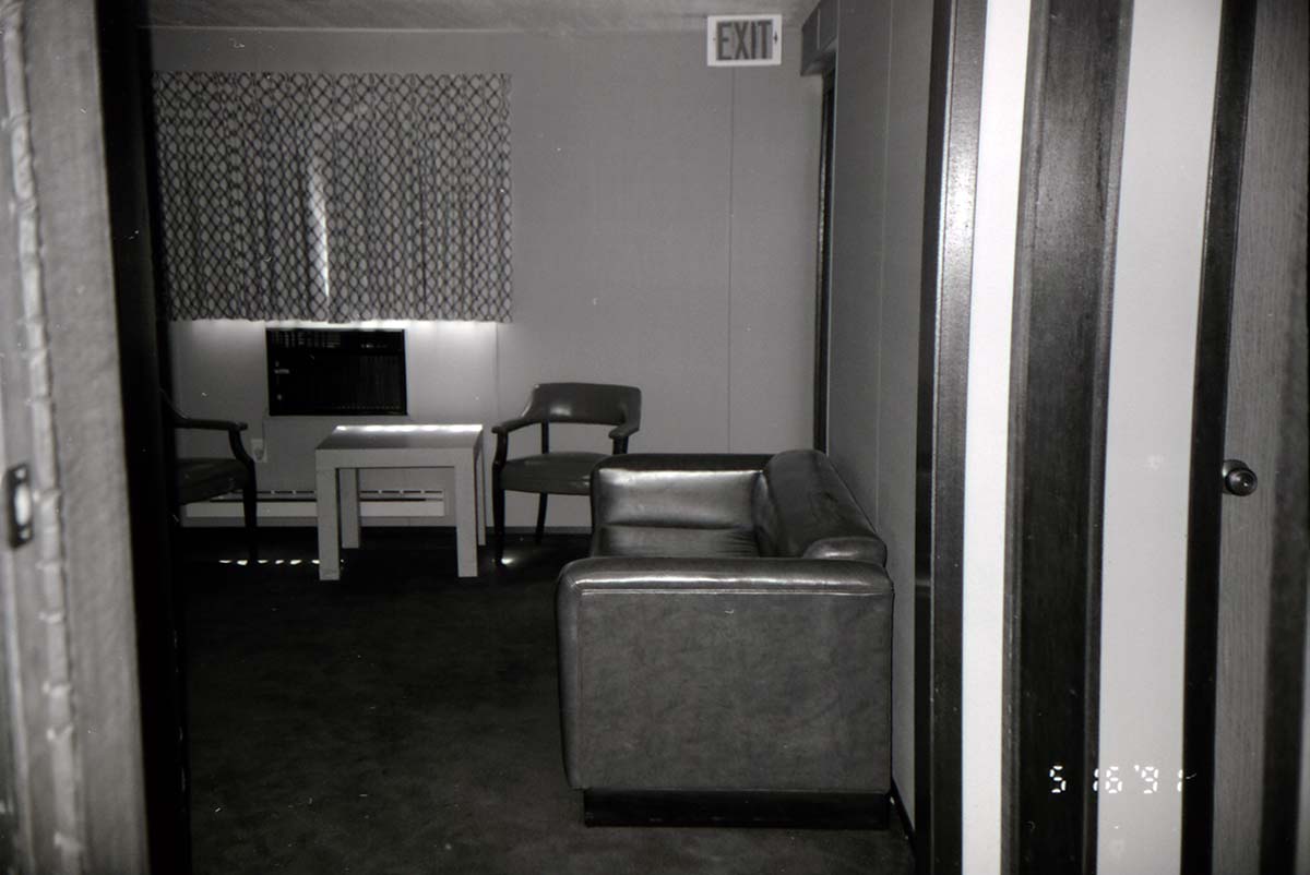 Couch and chairs in living room area of barracks. [Image possibly for comparative housing study]