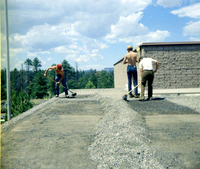 Three men spreading gravel during reroofing project. Bryce Canyon National Park.