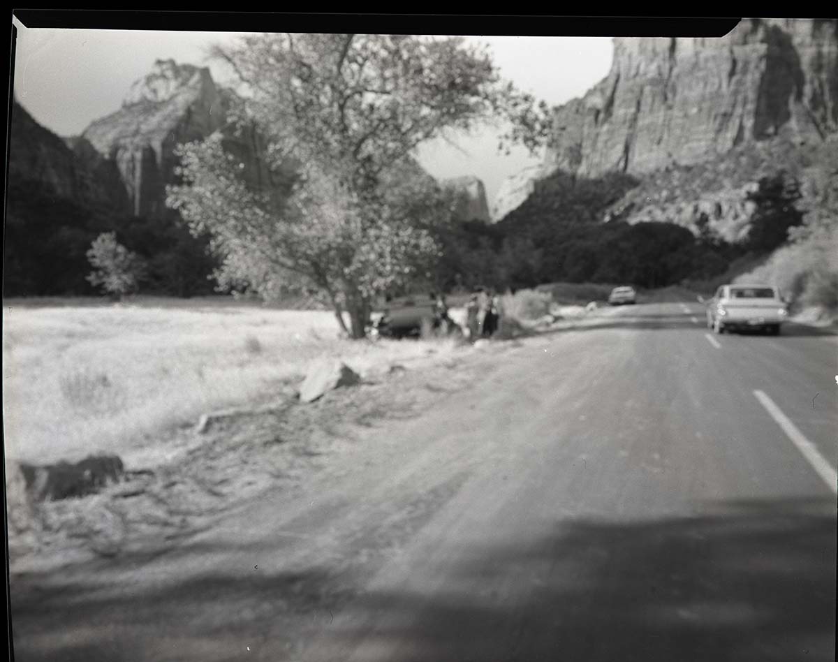 Auto accident 6 miles south of Zion Lodge. Car overturned just off road.