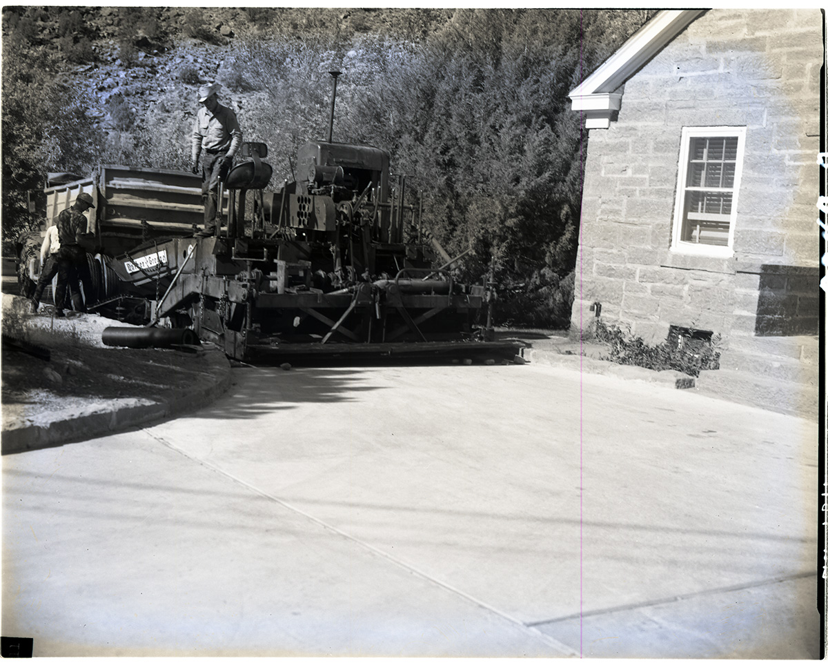 Road repair - near ranger dorm. Paving machinery at work laying hot mix.