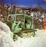 Color Photos of the parks snowplow/ tractor.