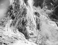 Weeping Rock. Handrail and rock wall masonry visible in foreground.