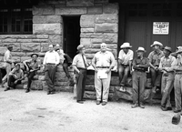Superintendent Paul R. Franke presenting award and gift to J. Mack Bean upon disability retirement. Maintenance men seated and standing alongside at Oak Creek warehouse.