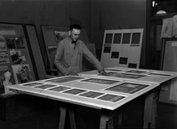 Worker at the Western Museum Laboratory (WML) assembling framed art for a museum exhibit.