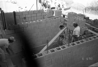 Workers performing construction duties during the construction of headquarters addition.