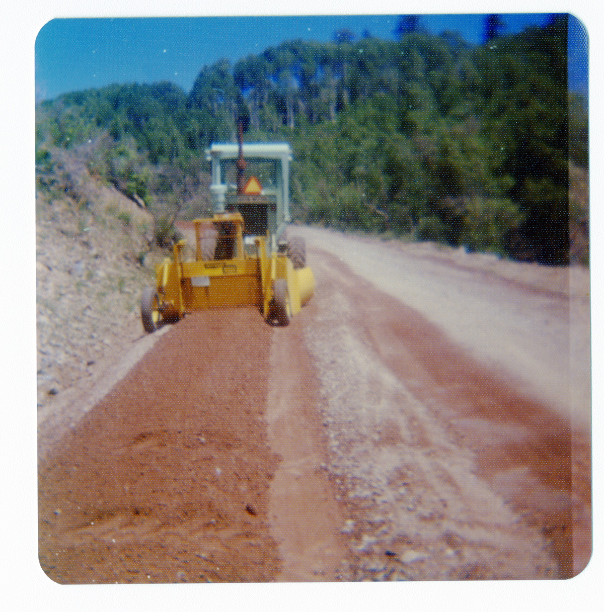 Construction vehicle performing road work along the Kolob Terrace Road.