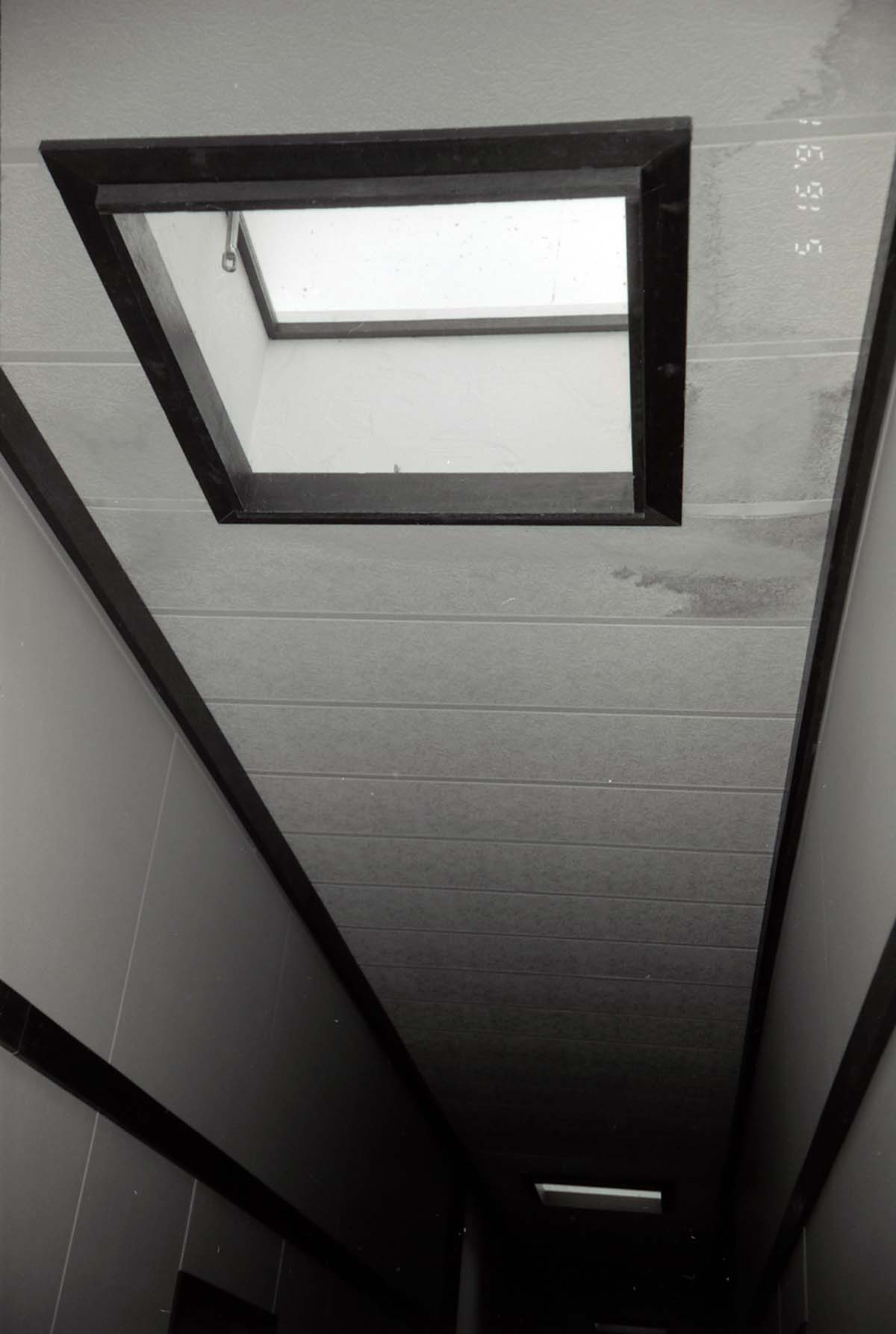 Ceiling and skylights in hallway of barracks. [Image possibly for comparative housing study]