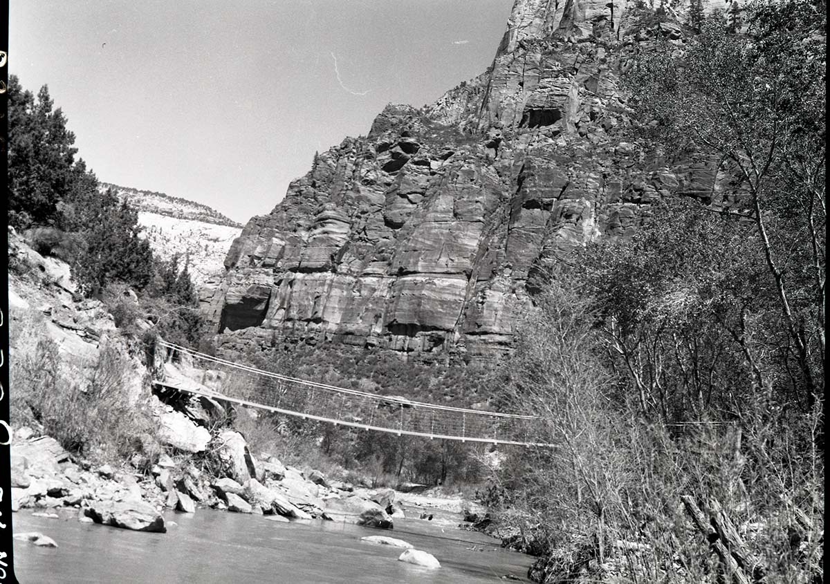 Suspension bridge across Virgin River, West Rim Trailhead rebuilt and relocated in spring of 1953.