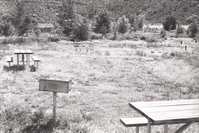 Picnic tables and grill at a campsite in Watchman Campground.