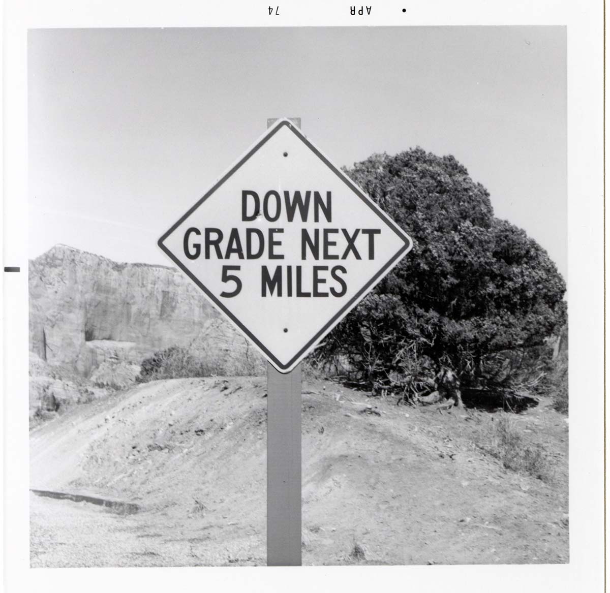 Road sign reading 'Down Grade Next 5 Miles' in Kolob Canyon.