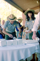 Color Photos of the parks 72nd anniversary celebrations- cake cutting, barbecue, speakers. Superintendent Harold Grafe serving cake with Blanca Stransky.