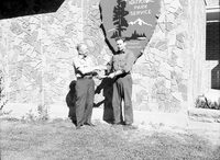 Superintendent Oberhansley presenting award to Donald DeMille for superior performance of duty, in front of Mission 66 Visitor Center and Museum.