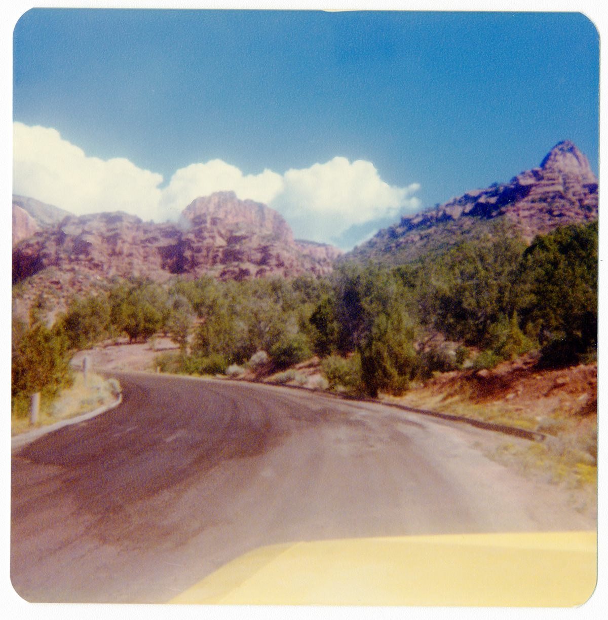 Road and surrounding landscape with mountains in the distance along the Kolob Terrace Road - North Unit.
