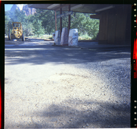 Tractor performing shoulder work along route 2 parking areas. Next to Utah Parks Company fuel pumps.