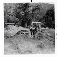 Construction vehicle cleaning and clearing in campground area.
